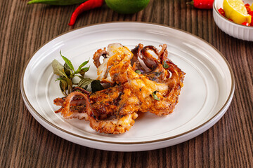 Gourmet grilled whole octopus served lime