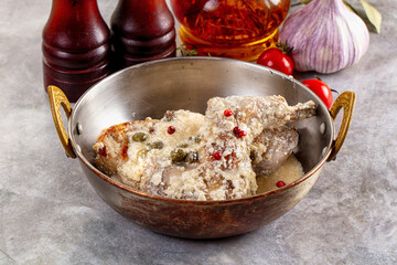 Roasted rabbit legs in cream sauce