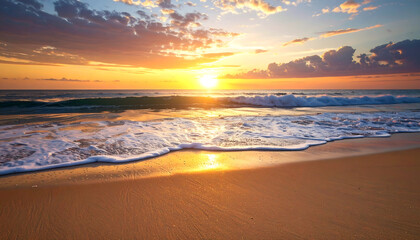Stunning sunset over ocean waves on sandy beach with golden sunlight