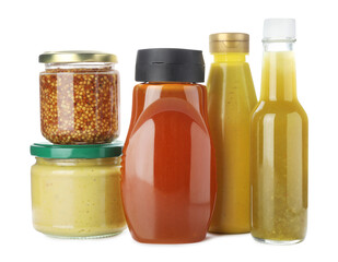 Bottles and jars with different tasty sauces isolated on white