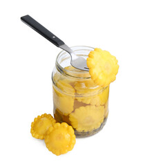 Fork with pickled pattypan squashes on jar against white background