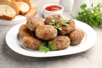 Tasty meat patties served on grey table, closeup