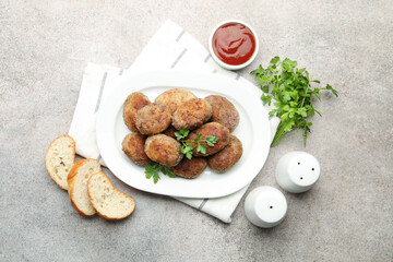 Tasty meat patties served on grey table, flat lay