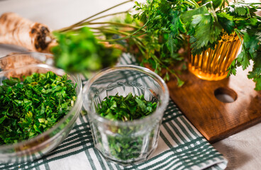 Preparing fresh parsley leaves to freezing for winter.