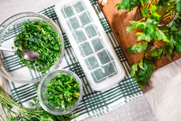 Preparing fresh parsley leaves to freezing for winter.