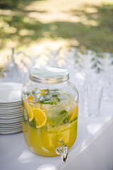 A large bottle of lemonade stands on the festive table