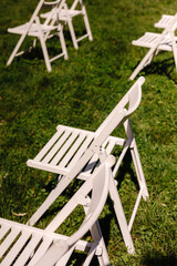 White festive chairs on a green lawn
