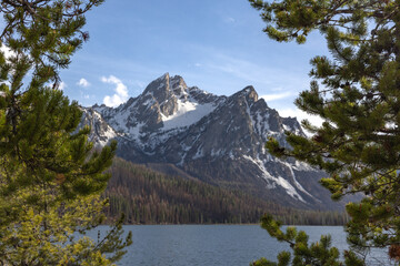 stanley lake in central idaho in sawtooth national forest with the mountain framed by two pine trees