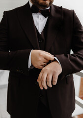 A close-up of a man adjusting his jacket