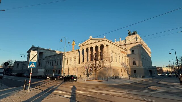 The magnificent Austrian Parliament Building in Vienna features neo-classical architecture, tall columns, and the Pallas Athene Fountain. Captured during golden hour