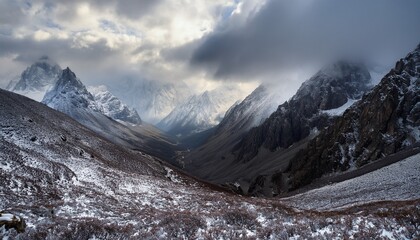 frosty peaks ascend steeply into grey cloudy sky clouds landscape