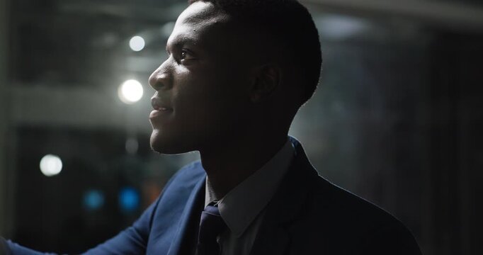 Glass wall, reading or man in office at night, sorting or creative strategy in brainstorming. Thinking, bokeh or marketing director in agency with board, planning or organizing on late shift.