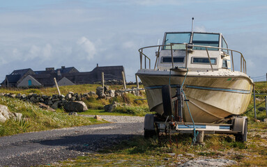 Large boat on trailer parked on driveway in Irish country side