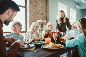 A funny warm family feast around a turkey table for thanksgiving and holiday joy with friends and relatives