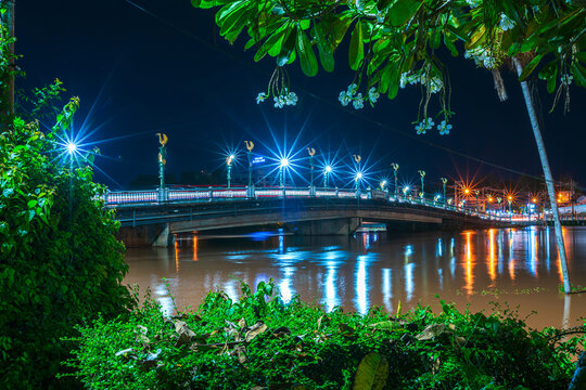 High water level of The color of Night traffic light on the road on the bridge (Eka Thot Sa Root Bridge) in Phitsanulok, Thailand.