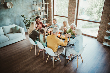 A warm Thanksgiving family gathering around a big table sharing food love and laughter in a cozy modern home