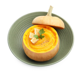 Tasty pumpkin cream soup with parsley and croutons served in pumpkin isolated on white