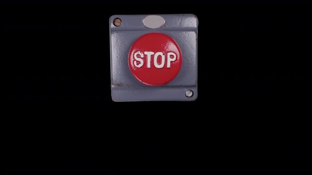 hand pressing an industrial stop button