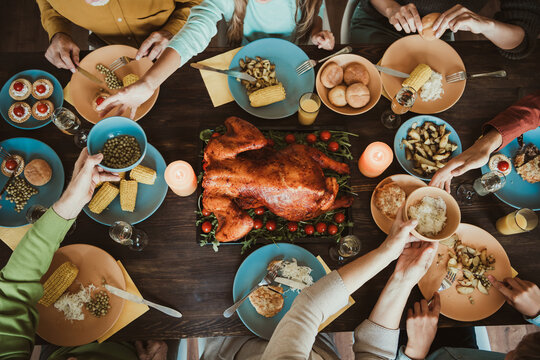 Thanksgiving table of family and friends big gathering of generations shares turkey corn and stories around a festive autumn meal