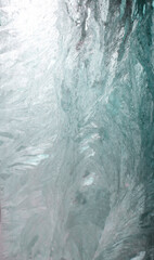 blue frost pattern on a window glass. winter background. Macro closeup wallpaper. Banner hoarfrost background template