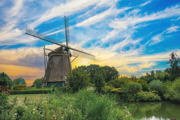 Old Dutch windmill in the Netherlands, traditional mill with a beautiful view of a clear, cloudy sky