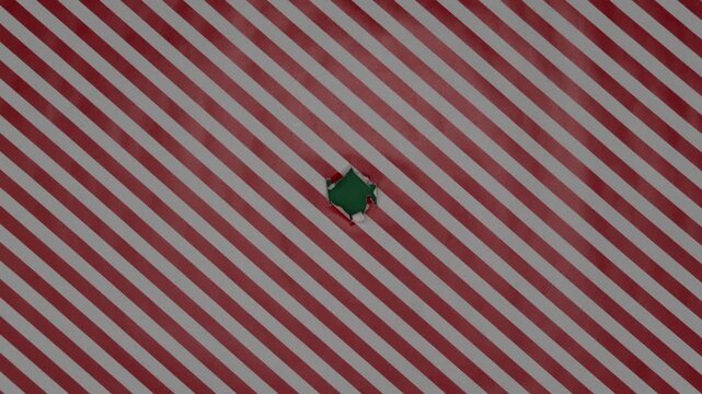 Christmas wrapping paper tears from the center on a green background. Stop motion. Layout for discounts, text, etc