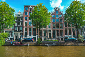 August 20, 2025, Amsterdam, Netherlands, view of the houses on the Oudezijds Voorburgwal river.