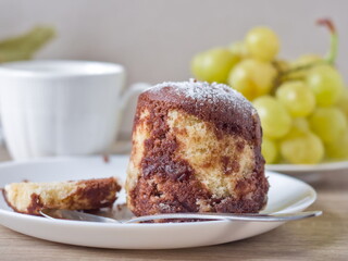 Marble Cake with Grapes - A slice of marble pound cake served on a plate, with fresh green grapes visible in the background