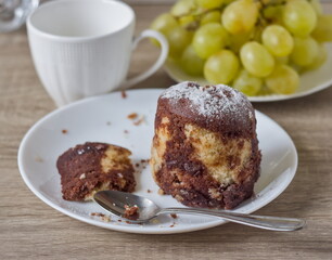 Close-up of a spoon cutting into a soft marble pound cake, showing the texture
