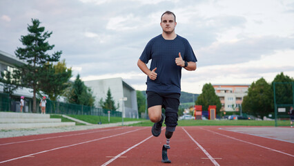 A person jogs on a track using a prosthetic leg under a cloudy sky in a training environment.