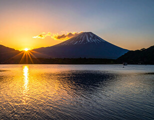 Fototapeta premium Majestic Sunrise Over Mount Fuji, Japan, Reflecting in Calm Lake Waters.