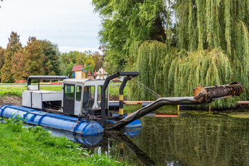 Dredging Machine in a Lush Pond