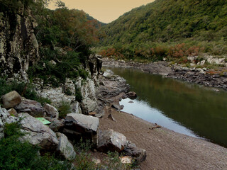 Mountain landscape with a river and rocks in the foreground,Brazil