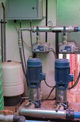 water pumping system, piping and plastic tanks, used for irrigation or water supply.