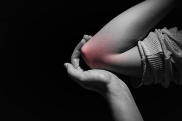 Woman showing elbow injury isolated showing red highlights pain relief concept, muscle pain due to...