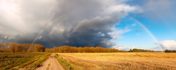 autumn landscape with a rainbow after a thunderstorm