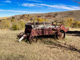 Old Rusty Wagon Resting in a Meadow in the Coal Miners Memorial Park above Red Lodge Montana in the Fall.