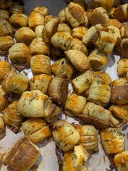 Close-up of savory pastries with herbs, golden brown and appetizing.