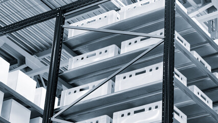 Row of white boxes on a shelf  dividers. boxes are stacked on top of each other