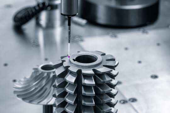 Operator inspection dimension metal parts by CMM after machining process in industrial factory.