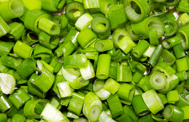 Sliced green onion rings.Finely chopped circles of bright green onion feathers.Green onion background.