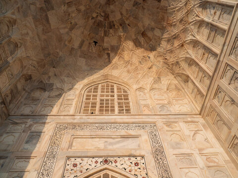 Extreme Close-up of White Marble Architecture and Relief Carvings of the Taj Mahal in Agra, India, Showing Intricate Floral Pietra Dura Inlays and Archways in Golden Sunlight
