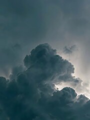 Dramatic and immense dark storm clouds gather in the vast, turbulent sky, revealing nature's raw power and the captivating beauty of an approaching weather event