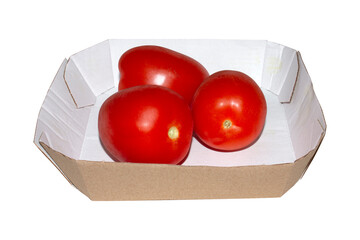 Tomatoes in a cardboard box on a white background.Ripe red tomatoes.Tomatoes from the garden.Tomatoes background.