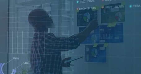 Analyst tapping tablet pointing charts generating stock graphs and updating data for finance review - Powered by Adobe