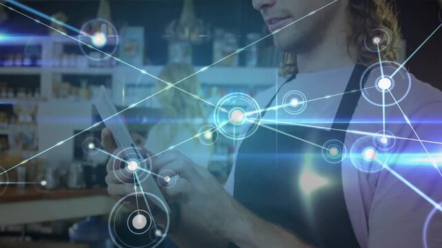 Barista tapping tablet screen at cafe counter, creating growing network map for data visualization