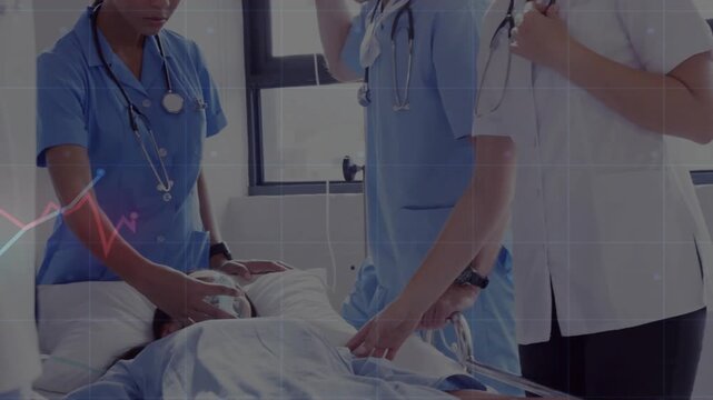 Nurse squeezing Ambu bag maintaining airway while provider checking pulse and staff listening chest