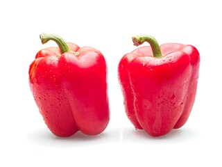   Two whole red bell peppers.