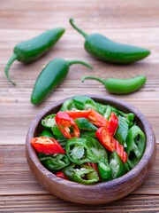  Studio photo of whole and sliced peppers.