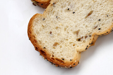 Sliced multigrain bread topped with pumpkin seeds, sunflower seeds, sesame, and black sesame.